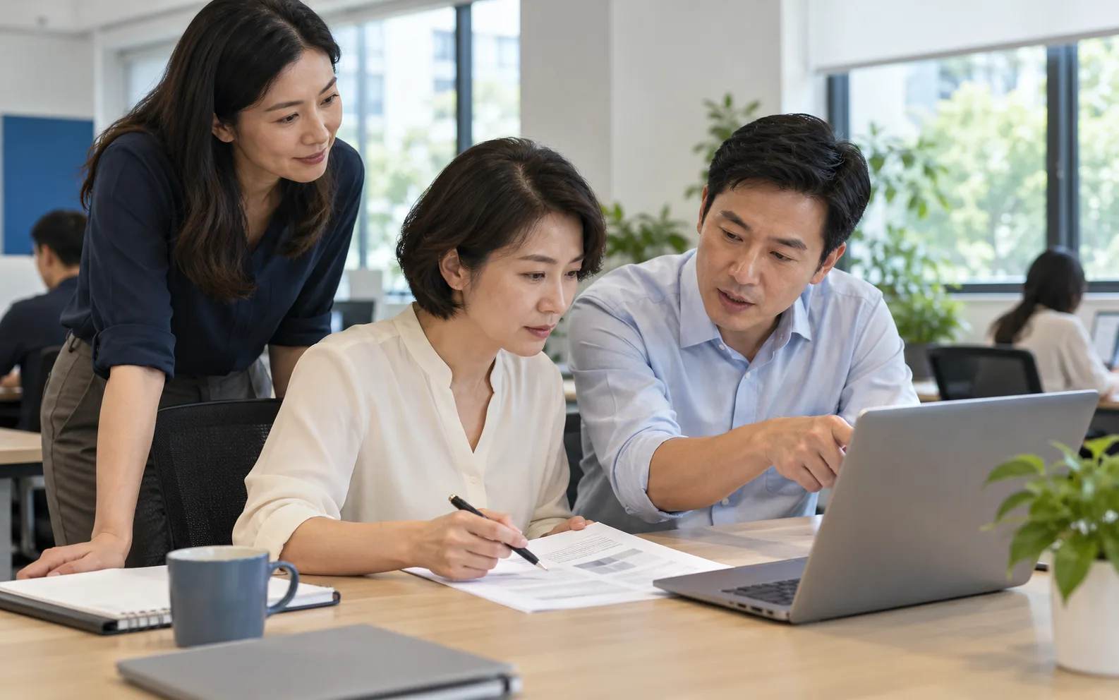 Illustrative colleagues comparing a draft on a laptop with a printed source document